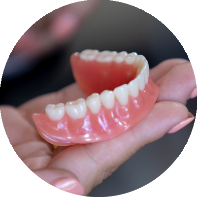 denture in hand